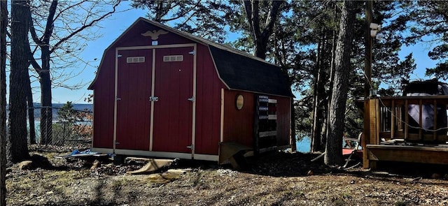 view of shed featuring fence