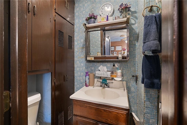 bathroom featuring toilet and vanity