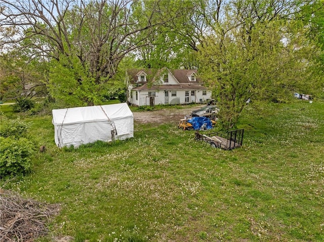 view of yard featuring an outdoor structure and an exterior structure
