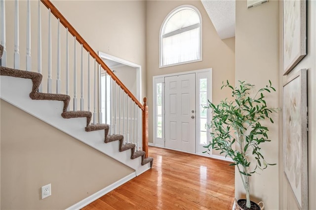 5405 Lakecrest Dr, Shawnee, KS 66218 - entrance foyer with a towering ceiling, wood finished floors, and stairs