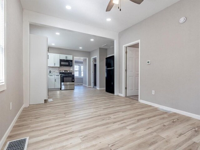 unfurnished living room with visible vents, baseboards, light wood-style floors, and a ceiling fan