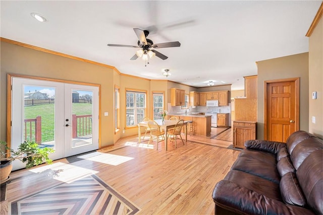 18125 Cypress Bnd, Basehor, KS 66007 - living room with a ceiling fan, french doors, light wood finished floors, ornamental molding, and recessed lighting