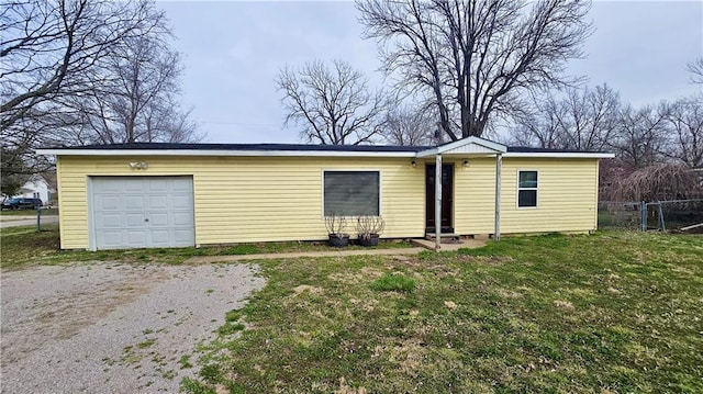 705 Heylman St, Fort Scott, KS 66701 - exterior space featuring a lawn, driveway, and fence