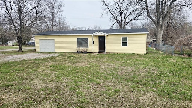 705 Heylman St, Fort Scott, KS 66701 - single story home with a garage, a front lawn, fence, and dirt driveway