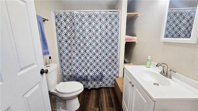 705 Heylman St, Fort Scott, KS 66701 - bathroom featuring toilet, a shower with shower curtain, vanity, and wood finished floors