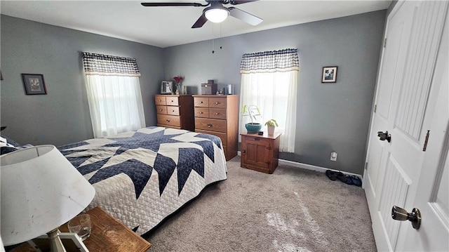 705 Heylman St, Fort Scott, KS 66701 - carpeted bedroom featuring a ceiling fan, baseboards, and multiple windows