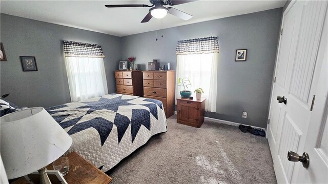 705 Heylman St, Fort Scott, KS 66701 - carpeted bedroom featuring a ceiling fan and baseboards