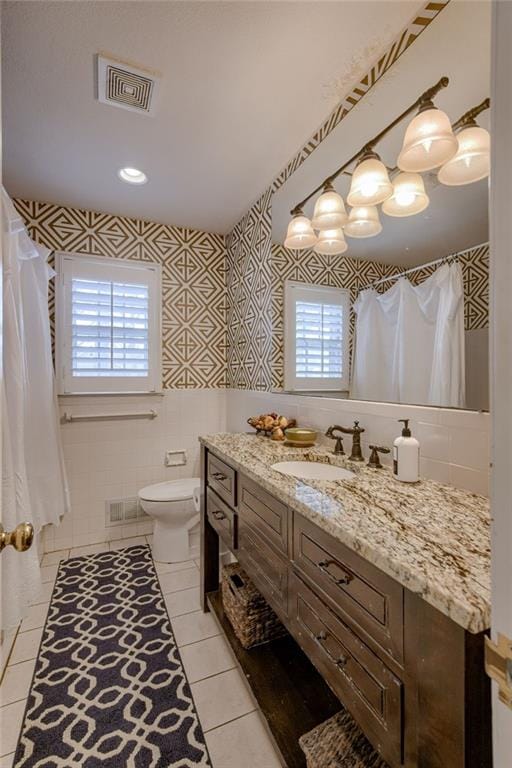 10318 Sagamore Rd, Leawood, KS 66206 - full bathroom with healthy amount of natural light, tile walls, tile patterned flooring, vanity, and a shower with shower curtain