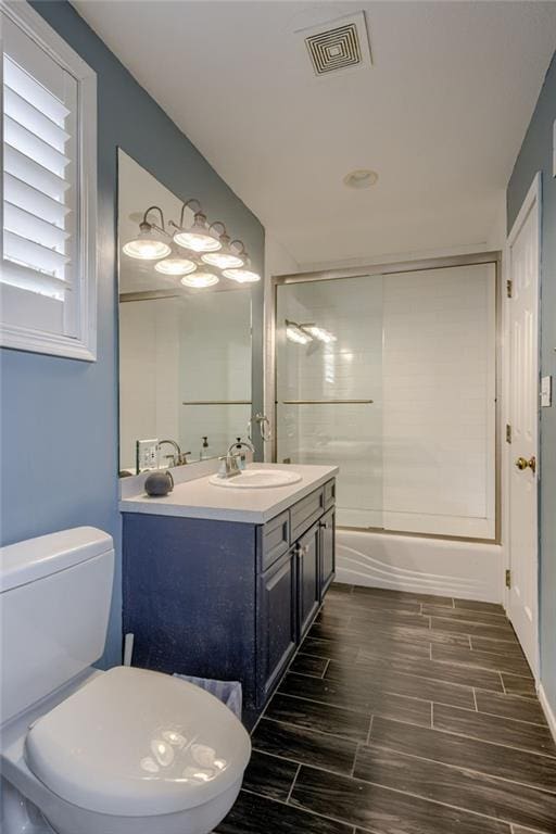 10318 Sagamore Rd, Leawood, KS 66206 - bathroom with vanity, wood tiled floors, and bathing tub / shower combination