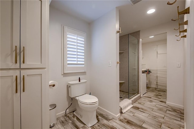 10318 Sagamore Rd, Leawood, KS 66206 - bathroom with wood finished floors, a stall shower, recessed lighting, and a closet