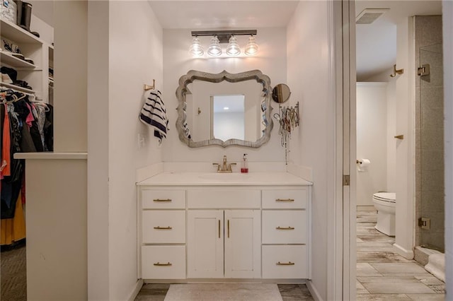 10318 Sagamore Rd, Leawood, KS 66206 - full bathroom with vanity, a spacious closet, and a shower stall