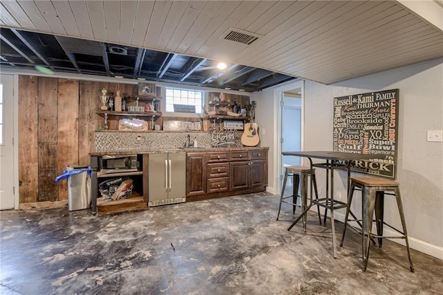10318 Sagamore Rd, Leawood, KS 66206 - bar area featuring stainless steel appliances, concrete floors, and wooden walls