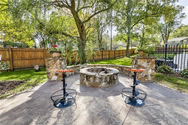 10318 Sagamore Rd, Leawood, KS 66206 - fenced backyard featuring a fire pit and a patio area