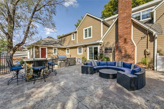 10318 Sagamore Rd, Leawood, KS 66206 - back of house with an outdoor living space, a patio, outdoor dining space, and a chimney