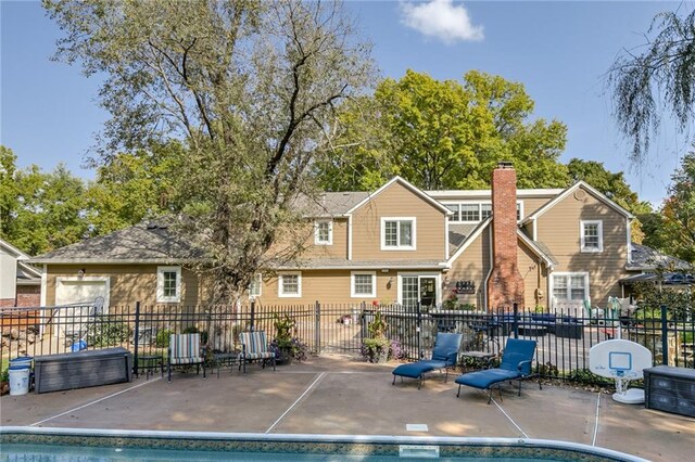 10318 Sagamore Rd, Leawood, KS 66206 - back of property with a patio and a chimney