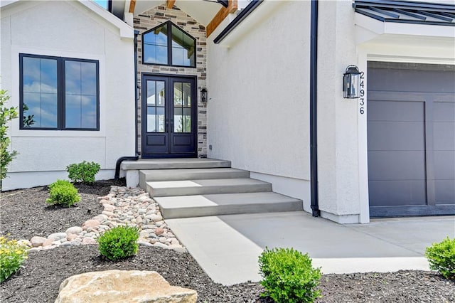 24936 W 98th Pl, Lenexa, KS 66227 - property entrance featuring stucco siding, french doors, and stone siding