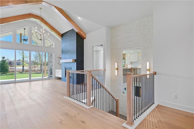 24936 W 98th Pl, Lenexa, KS 66227 - hall with an upstairs landing, high vaulted ceiling, wood finished floors, a chandelier, and beam ceiling
