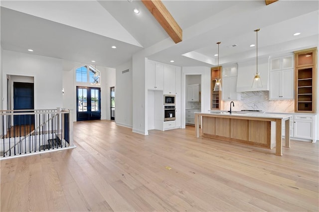 24936 W 98th Pl, Lenexa, KS 66227 - kitchen with oven, light wood-type flooring, decorative backsplash, recessed lighting, and high vaulted ceiling