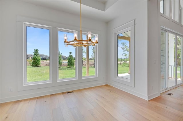 24936 W 98th Pl, Lenexa, KS 66227 - unfurnished dining area with a chandelier and light wood finished floors