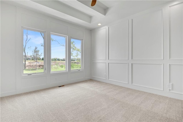 24936 W 98th Pl, Lenexa, KS 66227 - spare room with a decorative wall, light colored carpet, ceiling fan, and beamed ceiling