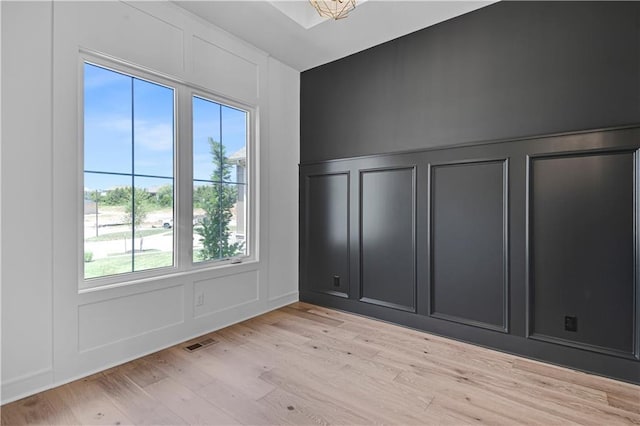 24936 W 98th Pl, Lenexa, KS 66227 - spare room featuring a decorative wall and light wood-type flooring