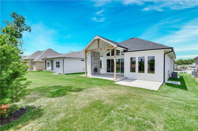 24936 W 98th Pl, Lenexa, KS 66227 - back of property with a patio area, a lawn, and roof with shingles