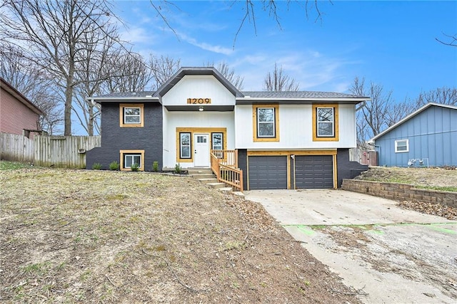 1209 S Lennox Dr, Olathe, KS 66062 - split foyer home with an attached garage, fence, and driveway