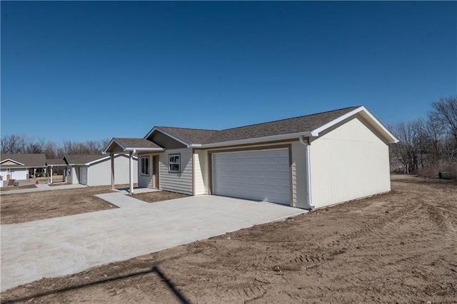 1702 N 2nd St, Neodesha, KS 66757 - ranch-style home with concrete driveway and a garage