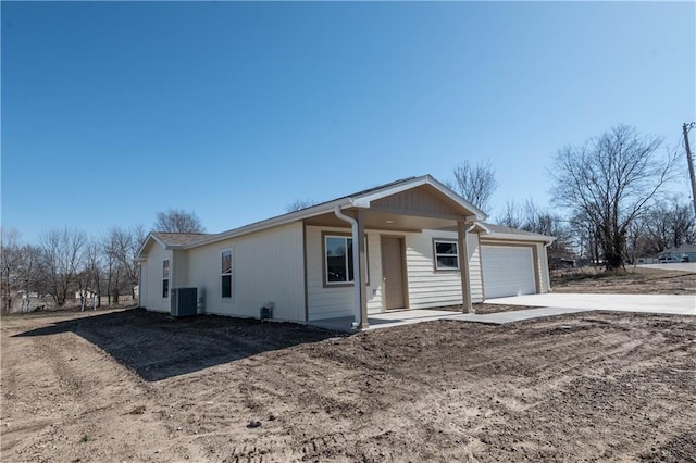 1702 N 2nd St, Neodesha, KS 66757 - single story home with an attached garage, driveway, and central AC