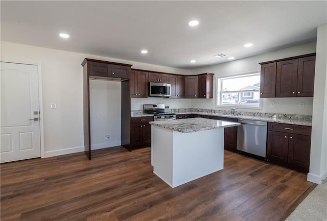 1702 N 2nd St, Neodesha, KS 66757 - kitchen with dark brown cabinets, appliances with stainless steel finishes, dark wood-style floors, and recessed lighting