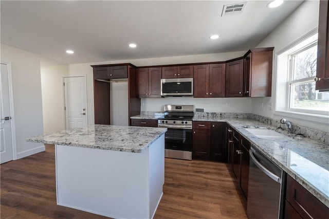 1702 N 2nd St, Neodesha, KS 66757 - kitchen with a sink, dark wood-style floors, a center island, appliances with stainless steel finishes, and dark brown cabinets