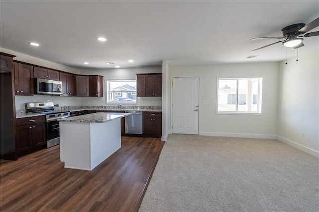 1702 N 2nd St, Neodesha, KS 66757 - kitchen featuring baseboards, a kitchen island, recessed lighting, dark brown cabinetry, and appliances with stainless steel finishes