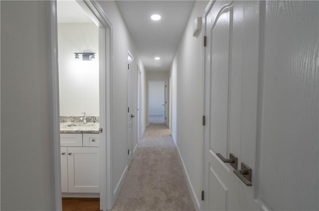 1702 N 2nd St, Neodesha, KS 66757 - hall featuring light carpet, recessed lighting, baseboards, and a sink