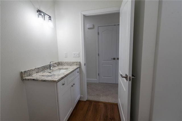 1702 N 2nd St, Neodesha, KS 66757 - bathroom with vanity, wood finished floors, and baseboards