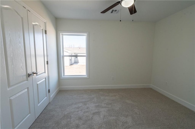 1702 N 2nd St, Neodesha, KS 66757 - carpeted empty room with visible vents, baseboards, and ceiling fan