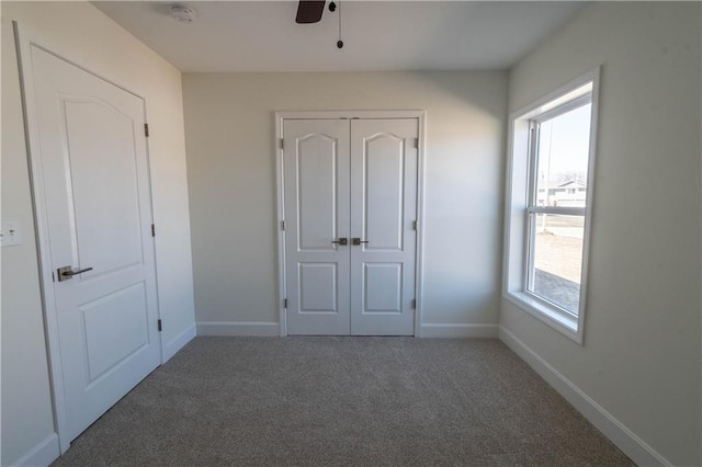 1702 N 2nd St, Neodesha, KS 66757 - unfurnished bedroom with a closet, carpet flooring, ceiling fan, and baseboards
