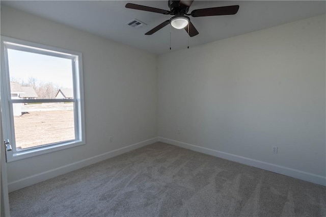 1702 N 2nd St, Neodesha, KS 66757 - carpeted empty room with visible vents, baseboards, and a ceiling fan