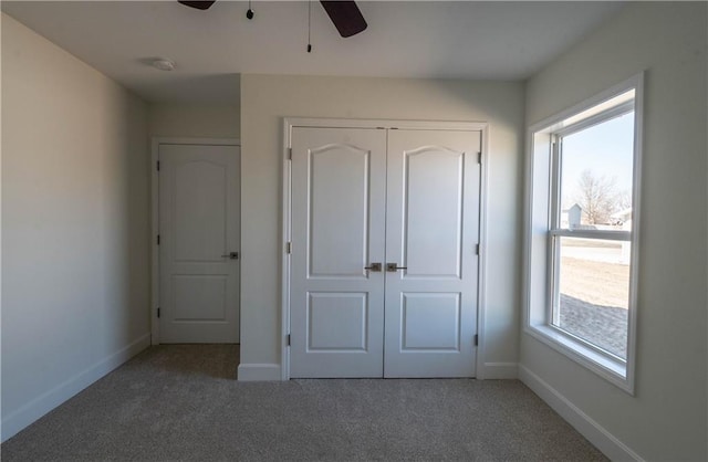 1702 N 2nd St, Neodesha, KS 66757 - unfurnished bedroom with a closet, carpet flooring, and baseboards