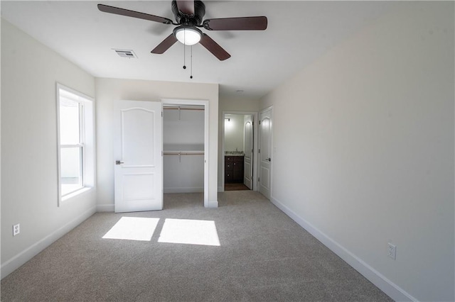 1702 N 2nd St, Neodesha, KS 66757 - unfurnished bedroom featuring light colored carpet, visible vents, a closet, and baseboards