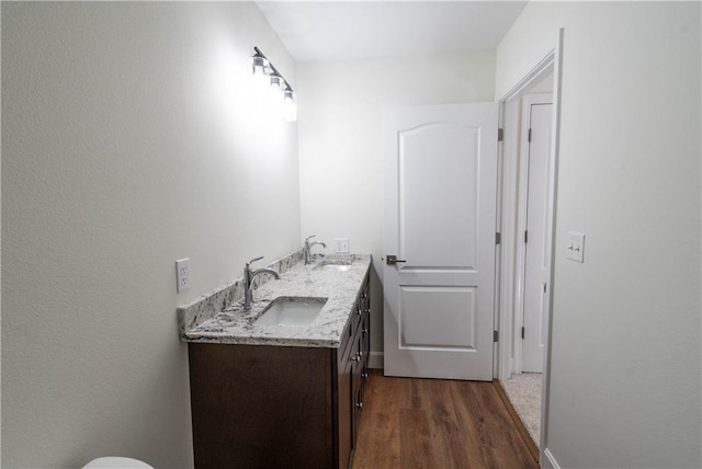 1702 N 2nd St, Neodesha, KS 66757 - bathroom featuring double vanity, wood finished floors, and a sink