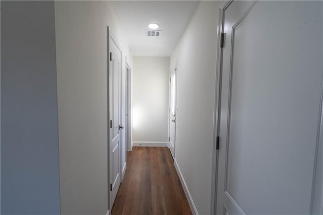 1702 N 2nd St, Neodesha, KS 66757 - hall featuring visible vents, baseboards, and dark wood-style floors