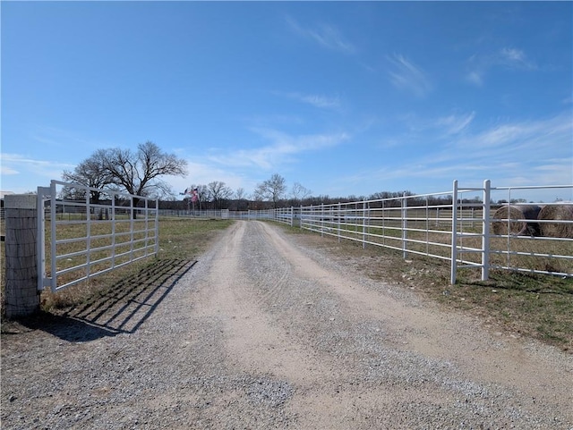 view of road featuring a gated entry and a rural view
