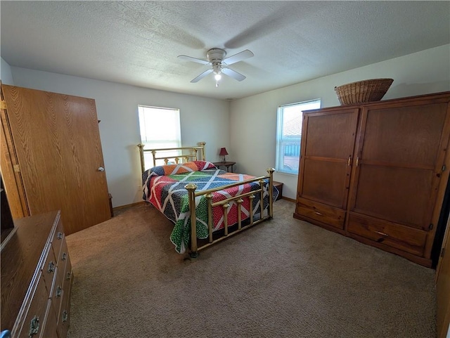 bedroom featuring a textured ceiling, ceiling fan, and carpet floors