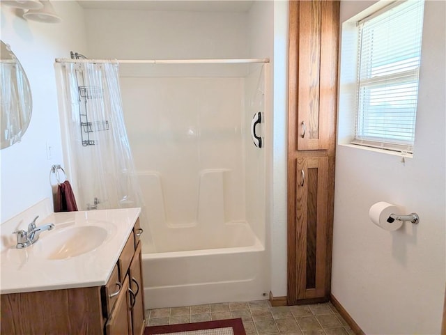 bathroom featuring tile patterned floors, vanity, shower / tub combo with curtain, and baseboards