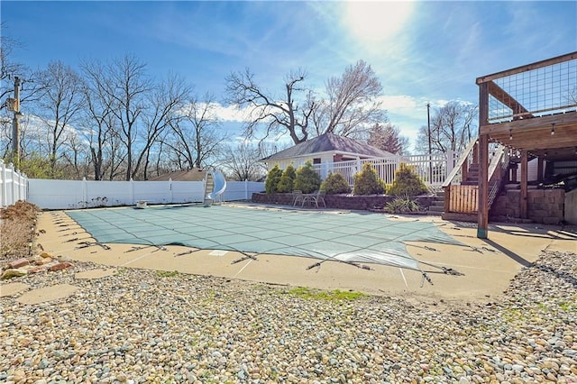 3402 Messanie St, Saint Joseph, MO 64501 - view of swimming pool featuring a water slide, a fenced backyard, stairway, a patio, and a wooden deck