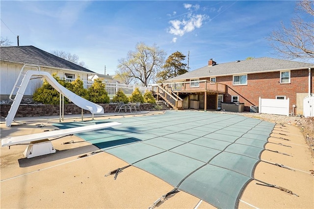 3402 Messanie St, Saint Joseph, MO 64501 - view of swimming pool featuring a diving board, stairway, a water slide, fence, and a deck