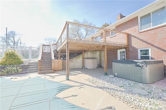 3402 Messanie St, Saint Joseph, MO 64501 - view of patio featuring a hot tub, stairway, a deck, and fence