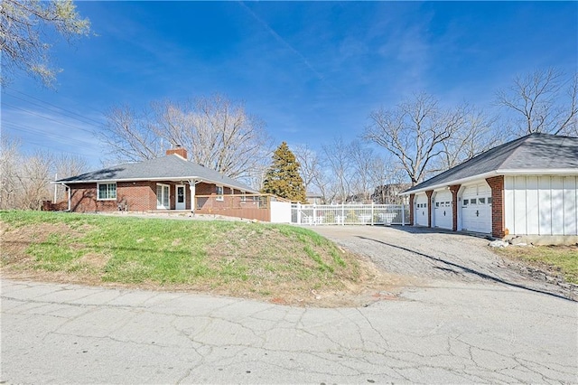 3402 Messanie St, Saint Joseph, MO 64501 - view of home's exterior featuring brick siding, a garage, a chimney, board and batten siding, and a gate