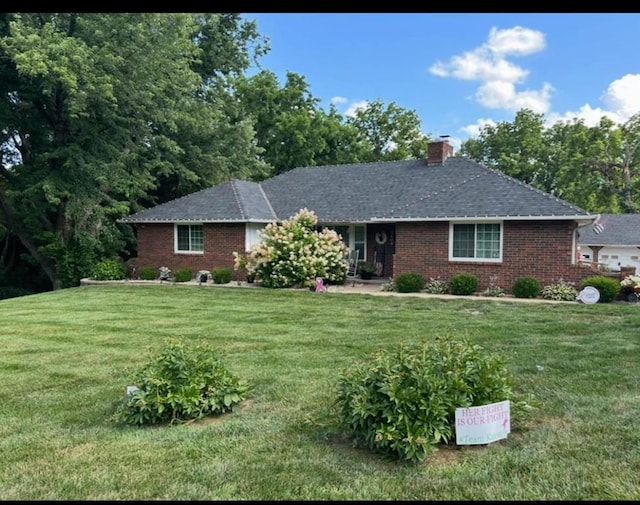 3402 Messanie St, Saint Joseph, MO 64501 - single story home with brick siding, a chimney, and a front yard