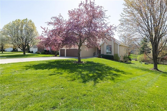 3015 SW 9th Ter, Lees Summit, MO 64081 - exterior space with an attached garage, driveway, a front yard, and stucco siding